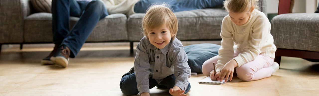 Kids freely playing on the floor after All Exterminating removed pests from their home.